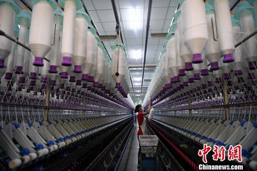 图为福建省尤溪县一家纺织厂工人在生产车间作业。(资料图片)<a target='_blank' data-cke-saved-href='http://www.chinanews.com/' href='http://www.chinanews.com/'>中新社</a>记者 张斌 摄 图为福建省尤溪县一家纺织厂工人在生产车间作业。(资料图片)<a target='_blank' data-cke-saved-href='http://www.chinanews.com/' href='http://www.chinanews.com/'>中新社</a>记者 张斌 摄