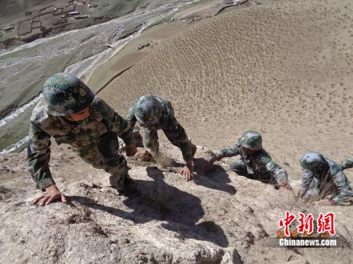 在拜克西片区,民兵手脚并用爬山。三连供图。 点击进入下一页