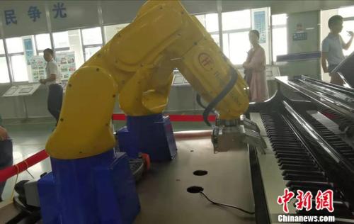 图为宏发科技工厂内，机器人在弹钢琴。 谢艺观 摄 