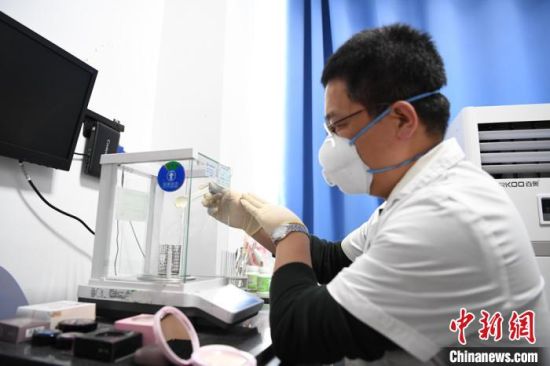 图为检验员对化妆品取样。 杨艳敏 摄 图为检验员对化妆品取样。 杨艳敏 摄