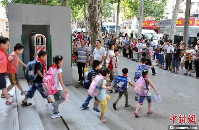 资料图：武汉一小学门外等待学生放学的家长们。<a target='_blank'  data-cke-saved-href='http://www.chinanews.com/' href='http://www.chinanews.com/'>中新社</a>发 张畅 摄