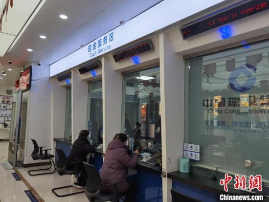 图为兰州市民在银行兑换新钞。 徐雪 摄 图为兰州市民在银行兑换新钞。 徐雪 摄