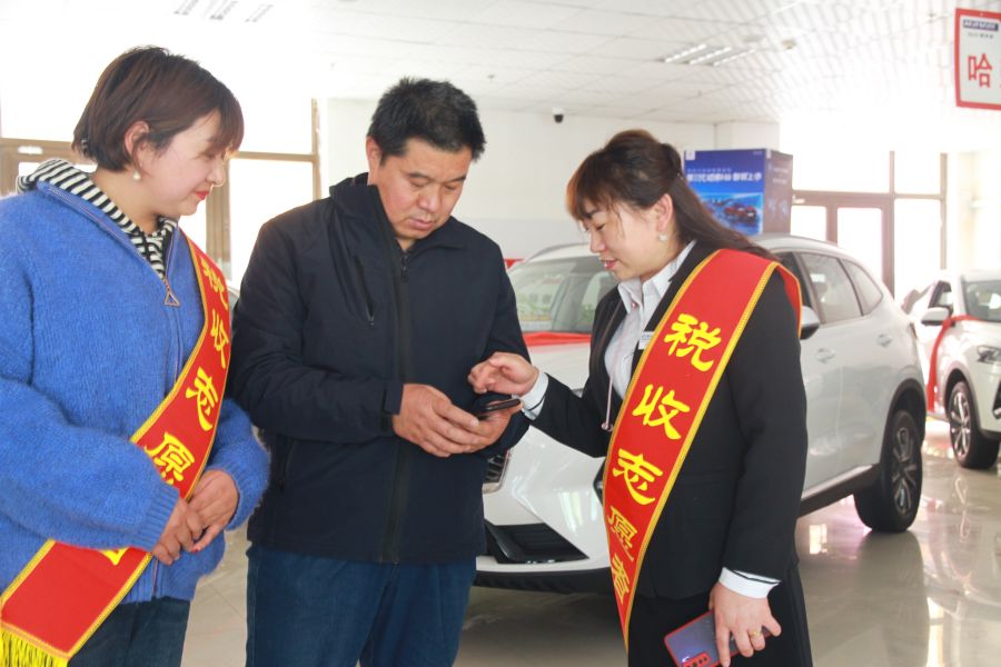 图为高台县瑞鑫汽车销售有限责任公司销售经理,作为税收志愿者向顾客辅导车购税申报.jpg 图为高台县瑞鑫汽车销售有限责任公司销售经理,作为税收志愿者向顾客辅导车购税申报.jpg