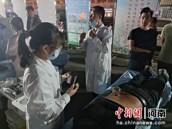 市民免费在唐河县“中医药文化夜市”上体验拔火罐服务。王宇 摄 市民免费在唐河县“中医药文化夜市”上体验拔火罐服务。王宇 摄