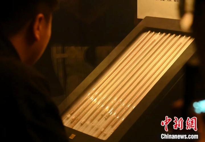 参观者近距离观看《仪礼》简上的文字。李亚龙 摄 参观者近距离观看《仪礼》简上的文字。李亚龙 摄